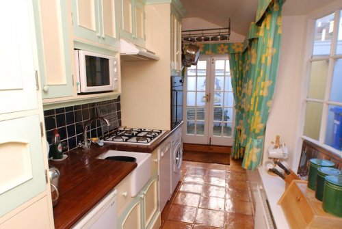 The Kitchen leads to French doors which open onto the courtyard, with Southwold Lighthouse just yards away.