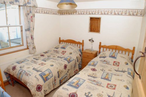 The Twin Bedroom at Lighthouse View overlooks the courtyard and the Lighthouse.